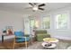 Open-concept living room with hardwood floors, neutral walls, stylish furniture, and great natural light at 120 Pine St, Carrboro, NC 27510