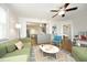 A cozy living room with hardwood floors, contemporary furniture, and an open view into the kitchen at 120 Pine St, Carrboro, NC 27510