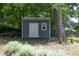 Storage shed with side window situated in a spacious, tree-filled backyard at 120 Pine St, Carrboro, NC 27510