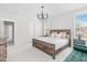 Spacious primary bedroom with wood bed frame, many pillows, and lots of natural light at 1203 Corkery Ridge Ct, Cary, NC 27519