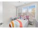 Bright bedroom with a pink headboard bed, desk, and large window at 1203 Corkery Ridge Ct, Cary, NC 27519