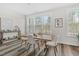 Sunlit dining area featuring wood floors, a modern table with seating for four, and large windows with natural views at 1203 Corkery Ridge Ct, Cary, NC 27519