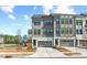 Modern townhome featuring a two-car garage, neutral-toned siding, and an inviting entryway in a residential neighborhood at 1203 Corkery Ridge Ct, Cary, NC 27519