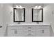 Bathroom featuring dual sink vanity with white cabinets, quartz counters, and framed mirrors at 1217 Linkwood Way, Fuquay Varina, NC 27526