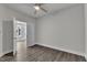 View of empty bedroom with ceiling fan and hardwood floors at 1217 Linkwood Way, Fuquay Varina, NC 27526