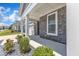 Inviting covered porch with stone accents and manicured landscaping at 1217 Linkwood Way, Fuquay Varina, NC 27526
