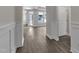Bright hallway featuring hardwood flooring and detailed trim work at 1217 Linkwood Way, Fuquay Varina, NC 27526