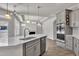 Open kitchen with stainless appliances, quartz countertops, and an island sink at 1217 Linkwood Way, Fuquay Varina, NC 27526