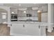 Modern kitchen featuring gray cabinets, stainless steel appliances, a white countertop island, and hardwood floors at 1217 Linkwood Way, Fuquay Varina, NC 27526
