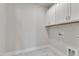 View of laundry room with white cabinets and flooring at 1217 Linkwood Way, Fuquay Varina, NC 27526