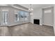 This living room features a fireplace, hardwood floors, and large windows at 1217 Linkwood Way, Fuquay Varina, NC 27526