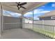 This screened in porch has a ceiling fan and a view of the fenced backyard at 1217 Linkwood Way, Fuquay Varina, NC 27526