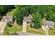 An aerial view of a home with an extended driveway and a well-manicured lawn surrounded by trees at 1304 Double Oak Ln, Willow Springs, NC 27592
