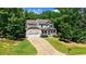 Charming two-story home with a covered front porch, a two-car garage, and a well-manicured lawn at 1304 Double Oak Ln, Willow Springs, NC 27592
