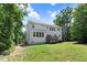 The backyard features a spacious lawn, several trees, and a wooden deck with a grill at 1304 Double Oak Ln, Willow Springs, NC 27592