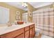 Bathroom featuring double sinks, vanity, a toilet, and shower with curtains at 1304 Double Oak Ln, Willow Springs, NC 27592