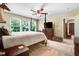 Bedroom featuring a large bed, ceiling fan, and windows offering ample natural light at 1304 Double Oak Ln, Willow Springs, NC 27592