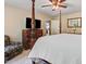Bedroom featuring a four-poster bed, dresser with TV, and comfortable sitting chair at 1304 Double Oak Ln, Willow Springs, NC 27592
