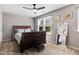 Comfortable bedroom is well-lit, and features a large bed, carpeted floors, and multiple framed pictures at 1304 Double Oak Ln, Willow Springs, NC 27592