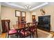 Elegant dining room with a tray ceiling, hardwood floors, classic decor, and lots of natural light at 1304 Double Oak Ln, Willow Springs, NC 27592
