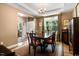 Elegant dining room with a tray ceiling, hardwood floors, classic decor, and lots of natural light at 1304 Double Oak Ln, Willow Springs, NC 27592