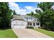 Charming two-story home with a covered front porch, a two-car garage, and a well-manicured lawn at 1304 Double Oak Ln, Willow Springs, NC 27592