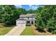 Charming two-story home with a covered front porch, a two-car garage, and a well-manicured lawn at 1304 Double Oak Ln, Willow Springs, NC 27592
