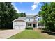 Charming two-story home with a covered front porch, a two-car garage, and a well-manicured lawn at 1304 Double Oak Ln, Willow Springs, NC 27592