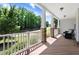 Covered porch with wood flooring, stone pillars, white railings and room to sit and relax at 1304 Double Oak Ln, Willow Springs, NC 27592