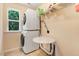 Laundry room featuring a stacked washer and dryer set next to a window for lots of natural light at 1304 Double Oak Ln, Willow Springs, NC 27592