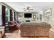 Inviting living room featuring hardwood floors, a cozy fireplace, and ample natural light from large windows at 1304 Double Oak Ln, Willow Springs, NC 27592