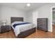 Bedroom featuring hardwood floors, a ceiling fan, and a comfortable bed with nightstand at 1400 Roslyn Dr # 17B, Burlington, NC 27215