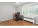 Light-filled room with hardwood floors and a large window overlooking the backyard at 1400 Roslyn Dr # 17B, Burlington, NC 27215