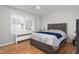 Bedroom featuring hardwood floors, a ceiling fan, and a comfortable bed at 1400 Roslyn Dr # 17B, Burlington, NC 27215