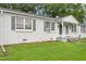View of the property featuring a green lawn and a well-kept exterior at 1400 Roslyn Dr # 17B, Burlington, NC 27215