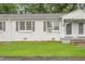 Exterior view of a well-maintained duplex with a green lawn and fresh paint at 1400 Roslyn Dr # 17B, Burlington, NC 27215