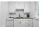Bright kitchen featuring white cabinetry, granite countertops, and a classic subway tile backsplash at 1400 Roslyn Dr # 17B, Burlington, NC 27215