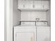 Well-lit laundry area featuring a white washer and dryer with subway tile backsplash at 1400 Roslyn Dr # 17B, Burlington, NC 27215