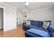 Comfortable living room featuring hardwood floors and a stylish blue sofa at 1400 Roslyn Dr # 17B, Burlington, NC 27215