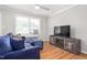 Inviting living room featuring hardwood floors, a window, and a rustic TV stand at 1400 Roslyn Dr # 17B, Burlington, NC 27215