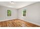 Bright bedroom with hardwood floors and two windows providing natural light at 1411 Hudson Ave, Durham, NC 27705