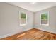 Inviting bedroom featuring hardwood floors and sunlit windows, creating a warm atmosphere at 1411 Hudson Ave, Durham, NC 27705