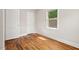 Simple bedroom with polished hardwood floors and natural light for comfortable living at 1411 Hudson Ave, Durham, NC 27705