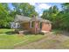 Classic brick house with a cozy front porch and a well-kept lawn, perfect for Gathering living at 1411 Hudson Ave, Durham, NC 27705