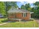Quaint brick home featuring a classic design, well-maintained lawn, and inviting entrance at 1411 Hudson Ave, Durham, NC 27705