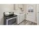 Modern kitchen with gray cabinets, white countertops, and updated stainless steel appliances at 1411 Hudson Ave, Durham, NC 27705