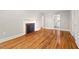 A brightly lit living room featuring a decorative fireplace and polished hardwood floors at 1411 Hudson Ave, Durham, NC 27705
