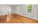 Bright and airy living room with hardwood floors, and a doorway view to the kitchen at 1411 Hudson Ave, Durham, NC 27705