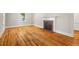 Bright living room with polished hardwood floors and a decorative fireplace at 1411 Hudson Ave, Durham, NC 27705