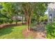 Backyard featuring a well-maintained lawn, lush landscaping, and patio with outdoor seating at 1504 Haventree Rd, Durham, NC 27713
